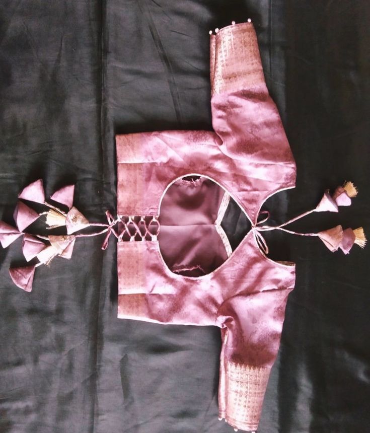 Festive wear blouse design with back-cut pattern and tassels