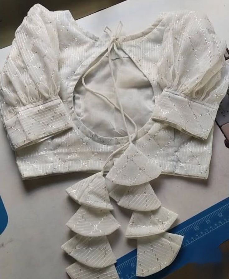Party wear blouse design in white with back opening and tassels