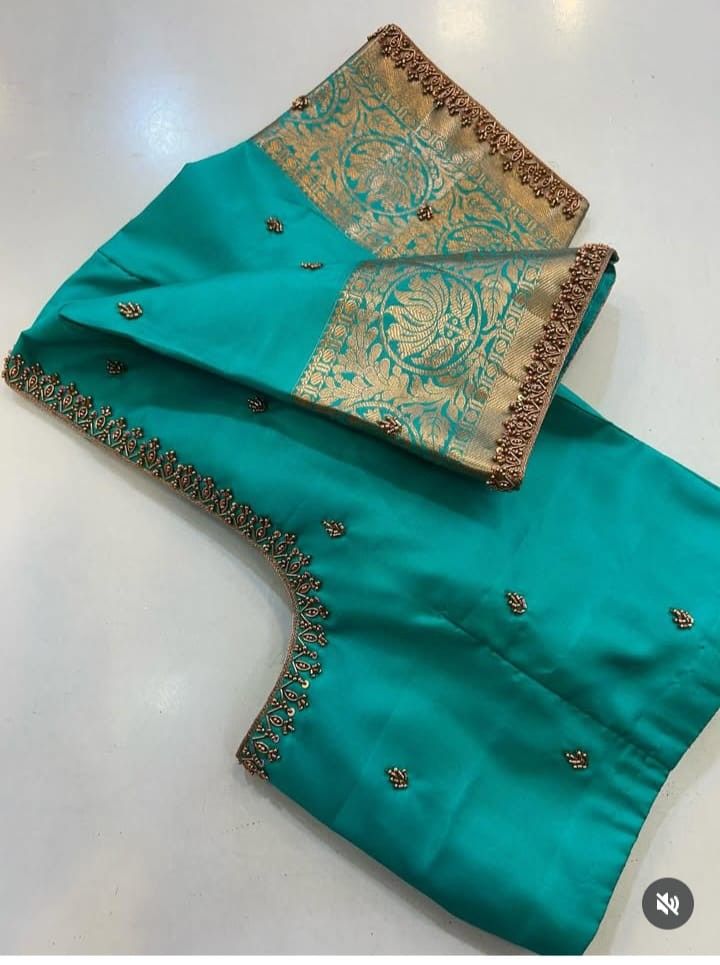 Teal silk blouse with deep U-back, dense gold Aari bead border and zari sleeve motif