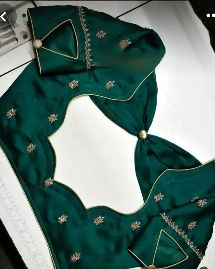 Emerald green silk blouse with gold-piped scalloped back cutout, gold button and embroidered sleeve V-cuts