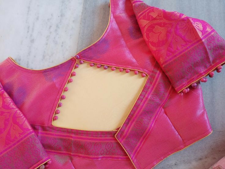 Fuchsia silk saree blouse with diamond back cutout, potli button trim, gold piping and zari sleeve borders