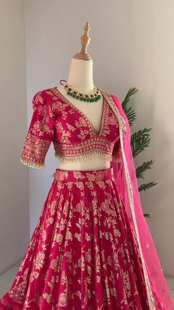 Magenta pink half saree lehenga with gold floral embroidery and beaded blouse borders on mannequin