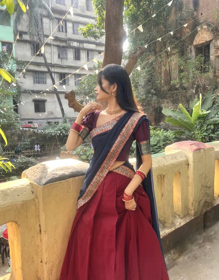 Designer maroon pleated half saree with navy blue dupatta, gold zari blouse borders and traditional jewellery — Porur tailoring